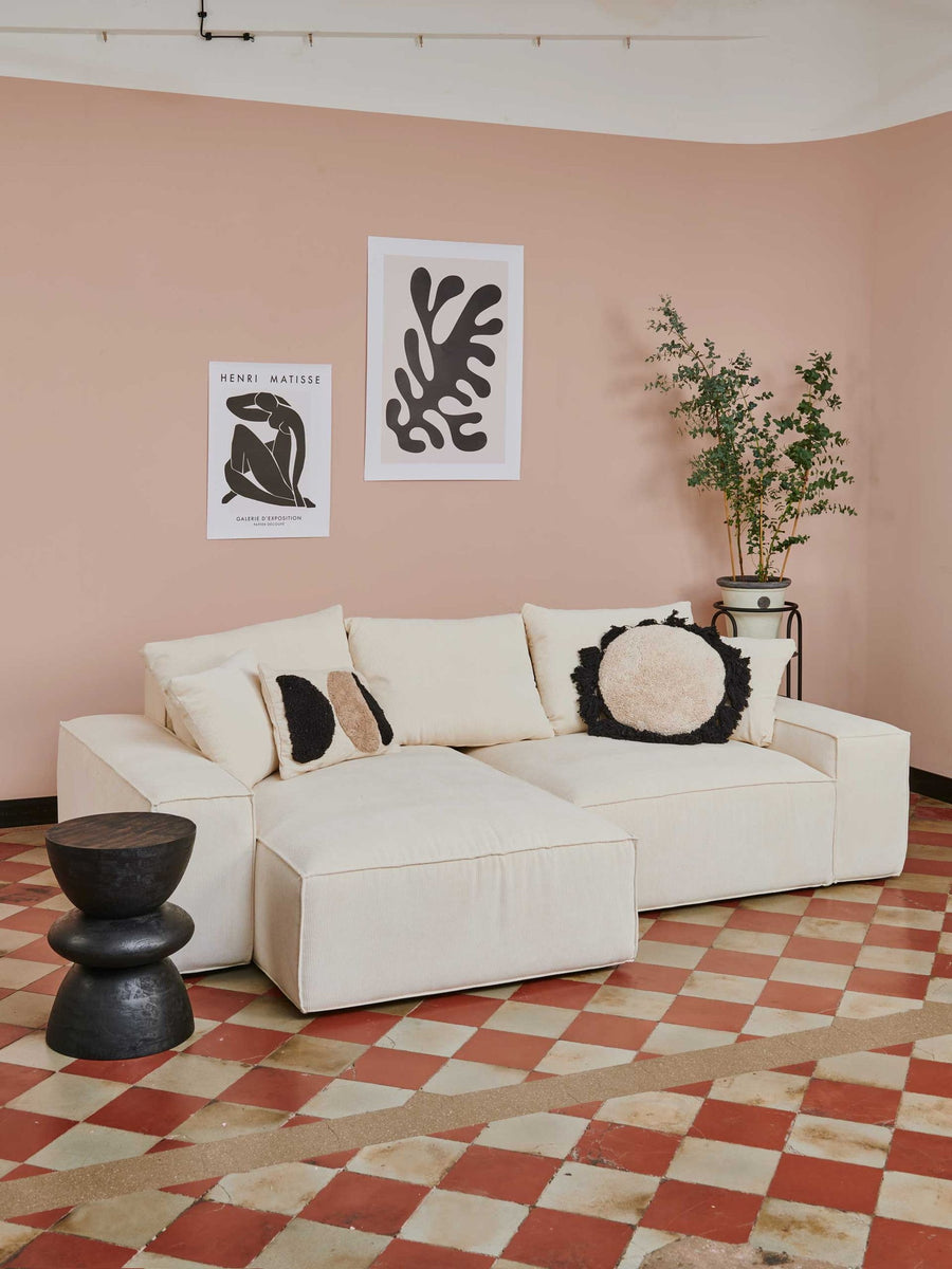 Canapé modulable Loft en tissu écru avec coussins décoratifs, mur rose poudré et carreaux de ciment